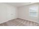 Well-lit bedroom featuring double doors and carpet flooring at 170 Wembury Ln, Troutman, NC 28166