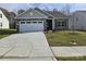 Newly built home with stone and siding accents, two-car garage, and landscaped lawn at 171 Wembury Ln, Troutman, NC 28166