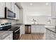 Modern kitchen with island, stainless steel dishwasher, and granite counters at 171 Wembury Ln, Troutman, NC 28166