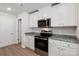 Modern kitchen with stainless steel appliances and granite countertops at 171 Wembury Ln, Troutman, NC 28166