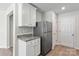 White kitchen cabinets, granite countertops, and stainless steel appliances at 171 Wembury Ln, Troutman, NC 28166