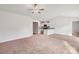 Spacious living room with neutral carpeting and hardwood flooring, open to kitchen at 171 Wembury Ln, Troutman, NC 28166