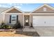 House exterior featuring neutral tones, landscaping, and a two-car garage at 1729 Nia Rd, Charlotte, NC 28215