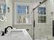 Stylish bathroom with a walk-in shower, new fixtures, and large window at 188 Mary Cir, Concord, NC 28025