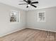 Bright bedroom with two windows, hardwood floors, and neutral walls at 188 Mary Cir, Concord, NC 28025