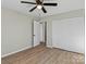 Well-lit bedroom with ceiling fan, hardwood floors, and built-in closet at 188 Mary Cir, Concord, NC 28025