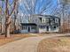 Two-story house with gray siding, long driveway, and mature trees in the yard at 188 Mary Cir, Concord, NC 28025