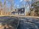 Ranch-style home with a long driveway and mature trees at 188 Mary Cir, Concord, NC 28025