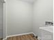 Clean laundry room with utility sink and vinyl flooring at 188 Mary Cir, Concord, NC 28025