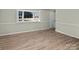 Bright living room with wood-look floors and a bay window at 188 Mary Cir, Concord, NC 28025