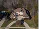 Large brick house with a three-car garage and landscaped yard at 2002 Streamview Ct, Waxhaw, NC 28173