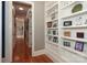 Hallway with built-in shelving and hardwood floors at 2002 Streamview Ct, Waxhaw, NC 28173