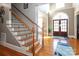 Elegant staircase with wrought iron railing and hardwood floors at 2002 Streamview Ct, Waxhaw, NC 28173