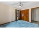 Bedroom with blue carpet, ceiling fan and large closet at 205 E Jimmy St, Candor, NC 27229