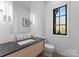 Stylish bathroom with a modern vanity, sleek fixtures, and natural light at 2103 Cortelyou Rd, Charlotte, NC 28211