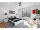 Bright bedroom with a modern bed, nightstands, and a large window with natural light at 2103 Cortelyou Rd, Charlotte, NC 28211
