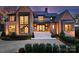 Elegant brick home with a grand entrance, highlighted by large windows, a modern staircase, and professional landscaping at 2103 Cortelyou Rd, Charlotte, NC 28211