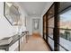 Bright hallway with hardwood floors, designer mirror, and natural light, creating an open and welcoming atmosphere at 2103 Cortelyou Rd, Charlotte, NC 28211