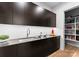 Modern kitchen featuring sleek cabinets, stainless steel sink, pantry and wood floors at 2103 Cortelyou Rd, Charlotte, NC 28211