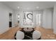 Bright and modern living room with hardwood floors, white sofa, round coffee table, and elegant decor at 2103 Cortelyou Rd, Charlotte, NC 28211