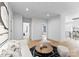 Open living space with hardwood floors, white sofa, and black and white decor at 2103 Cortelyou Rd, Charlotte, NC 28211
