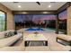 Inviting outdoor living space with comfortable seating, offering a serene view of the stunning pool area and landscaped backyard at 2103 Cortelyou Rd, Charlotte, NC 28211