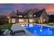 Expansive backyard showcasing a pristine pool, outdoor seating, and lush landscaping, ideal for leisure and gatherings at 2103 Cortelyou Rd, Charlotte, NC 28211