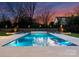 Luxurious pool featuring in-pool decor and manicured landscaping, perfect for relaxation and outdoor entertainment at 2103 Cortelyou Rd, Charlotte, NC 28211