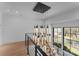 Modern staircase with a unique chandelier and natural light from large windows at 2103 Cortelyou Rd, Charlotte, NC 28211