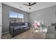 Bright bedroom with a daybed, a desk, and a large window at 2444 Moher Cliff Dr, Fort Mill, SC 29707