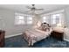 Inviting bedroom with soft lighting, floral bedding, a ceiling fan, and a comfortable atmosphere at 251 Gleneagles E Rd, Statesville, NC 28625