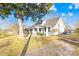 White house with mature trees, a gravel driveway and a partially visible street at 257 Jefferson St, Statesville, NC 28677