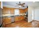 Kitchen boasts wood cabinets, stainless steel appliances, and hardwood floors at 26671 Doc Rd, Albemarle, NC 28001