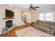 Living room with hardwood floors, fireplace, and access to staircase at 26671 Doc Rd, Albemarle, NC 28001