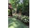 Landscaped backyard with artificial turf and white flowers at 270 Bent Tree Dr, Stanley, NC 28164