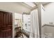 Simple bathroom with a shower/tub, and a wood chair at 302 S College St, Monroe, NC 28112