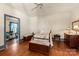 Bedroom with hardwood floors, ceiling fan, and ample closet space at 302 S College St, Monroe, NC 28112