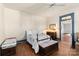 Bright bedroom with hardwood floors, ceiling fan and ample closet space at 302 S College St, Monroe, NC 28112