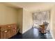 Charming bedroom with a rocking chair and dark hardwood floors at 302 S College St, Monroe, NC 28112