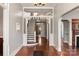 Grand entryway with hardwood floors, intricate staircase, and decorative screen at 302 S College St, Monroe, NC 28112