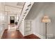 Entryway with hardwood floors, staircase, and built-in shelving at 302 S College St, Monroe, NC 28112
