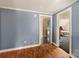 Simple hallway connecting bedrooms with hardwood floors and light blue walls at 302 S College St, Monroe, NC 28112