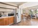 Kitchen with stainless steel refrigerator and wood cabinets at 302 S College St, Monroe, NC 28112