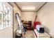 Functional laundry/storage room with ample shelving and exterior access at 302 S College St, Monroe, NC 28112