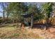 Rustic shed nestled in a private, wooded backyard at 302 S College St, Monroe, NC 28112
