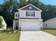 Two-story house with gray and white siding, a two-car garage, and landscaping at 3242 Maple Ridge Dr, Gastonia, NC 28052