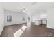 Bright living room featuring hardwood floors, large windows, and an open floor plan at 3242 Maple Ridge Dr, Gastonia, NC 28052