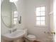 Simple bathroom with white vanity, toilet and patterned window at 4030 Garden Oak Dr, Indian Trail, NC 28079