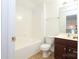 Clean bathroom with tub, toilet and vanity with dark brown cabinets at 4030 Garden Oak Dr, Indian Trail, NC 28079