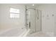 Bathroom features a shower and corner soaking tub at 4030 Garden Oak Dr, Indian Trail, NC 28079
